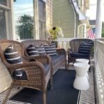 black and white front porch decor with white accent tables
