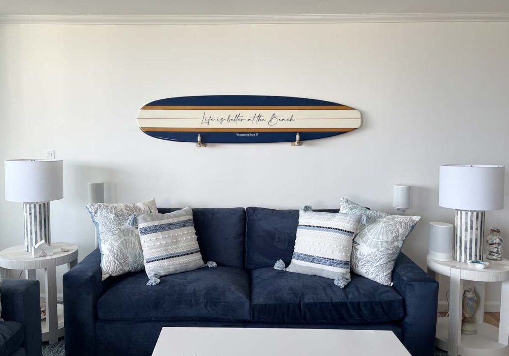 surf board artwork over navy sofa