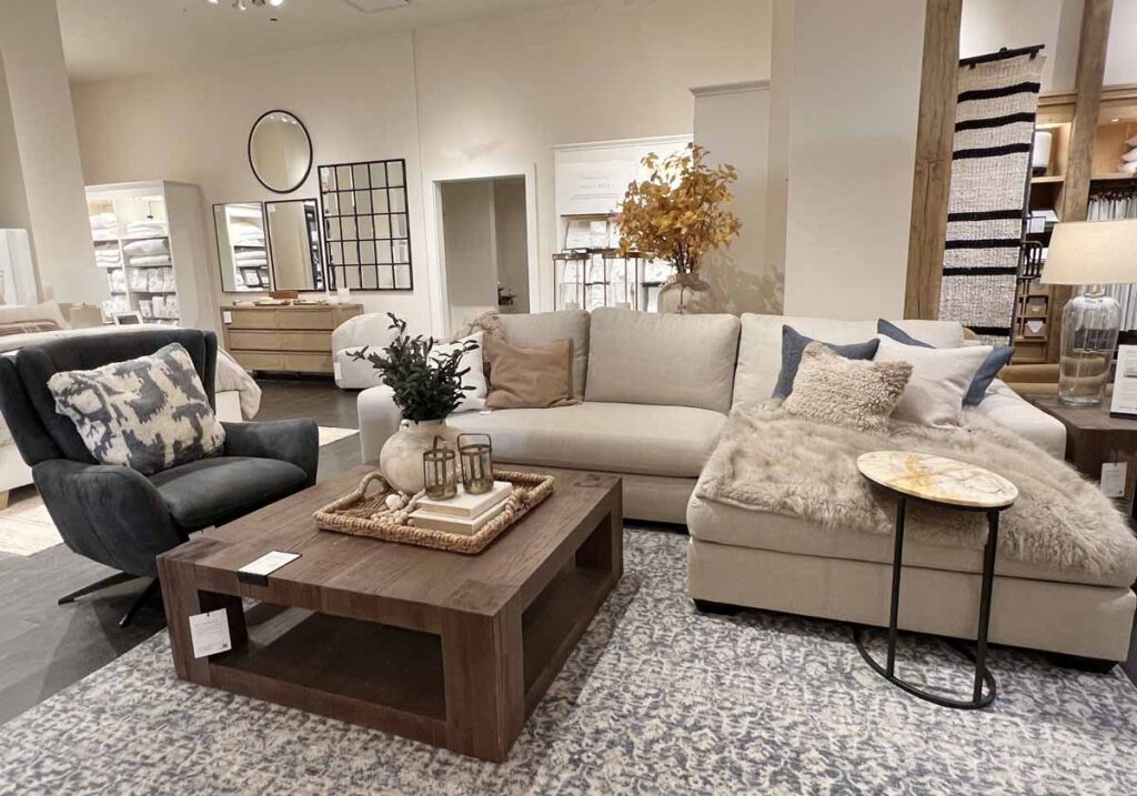 beige sofa blue leather chair and pillows