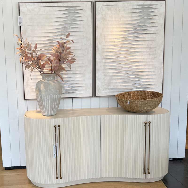 curved cabinet with art above